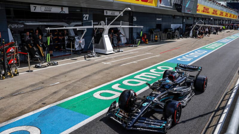 George Russell drives past APX GP pit at 2023 British Grand Prix