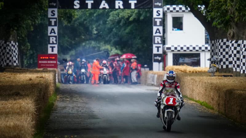 Kevin Schwantz blasts away from Goodwood Festival of Speed startline ahead of Mat Oxley