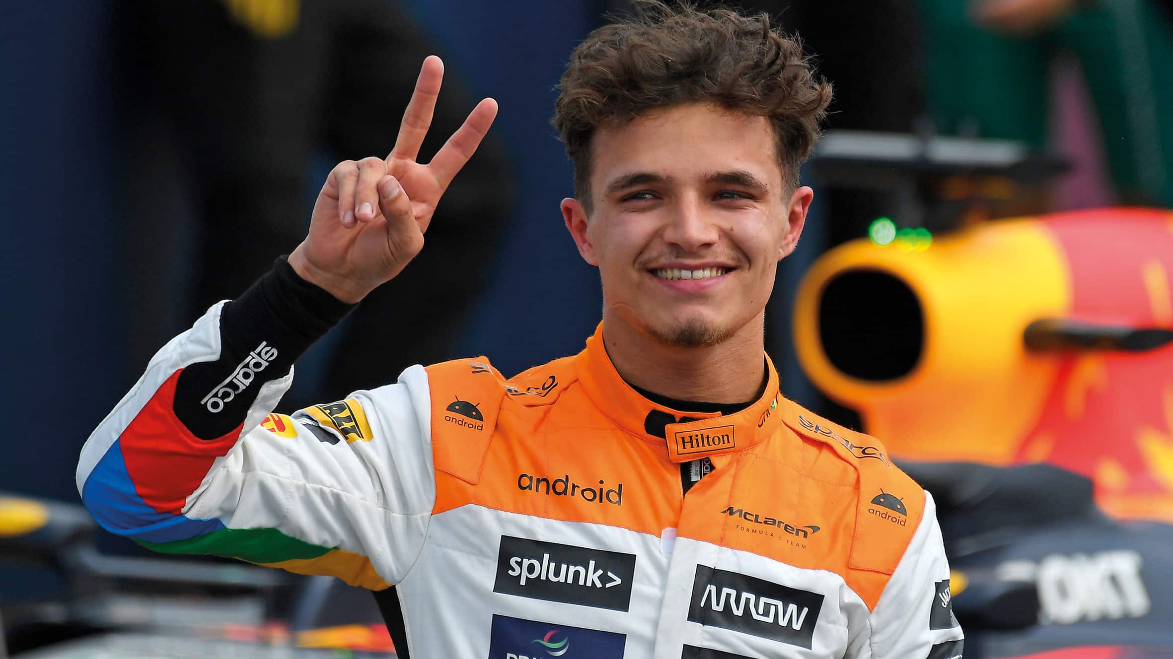 Lando Norris holds up a peace sign