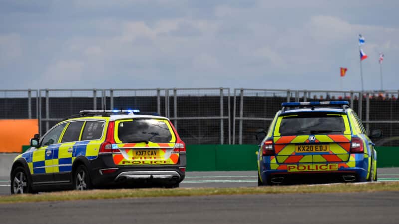 Police cars at 2022 British GP after track invasion