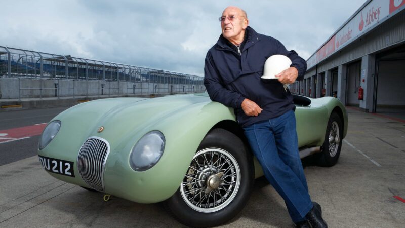 Stirling Moss stans with Jaguar C-Type