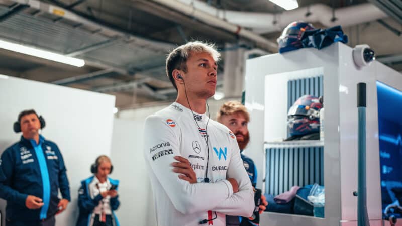Alex Albon with arms crossed in Williams pit garage