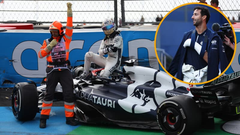 Daniel Ricciardo sits on crashed AlphaTauri holding his broken hand at 2023 Dutch Grand Prix