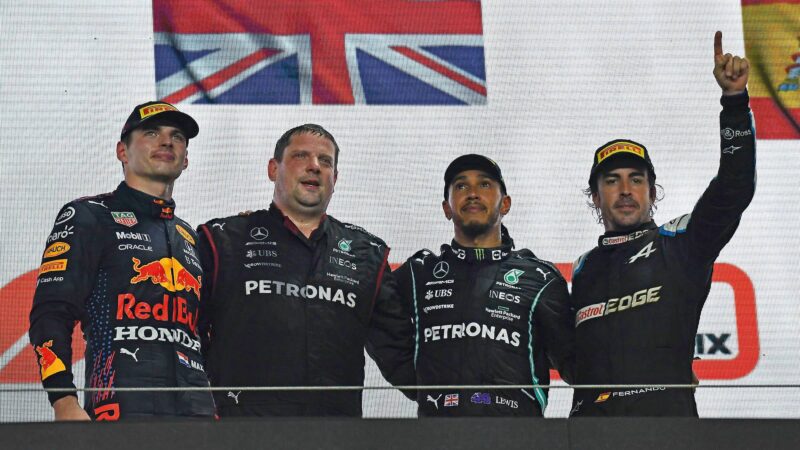 Max Verstappen, Lewis Hamilton and Fernando Alonso stand on the podium
