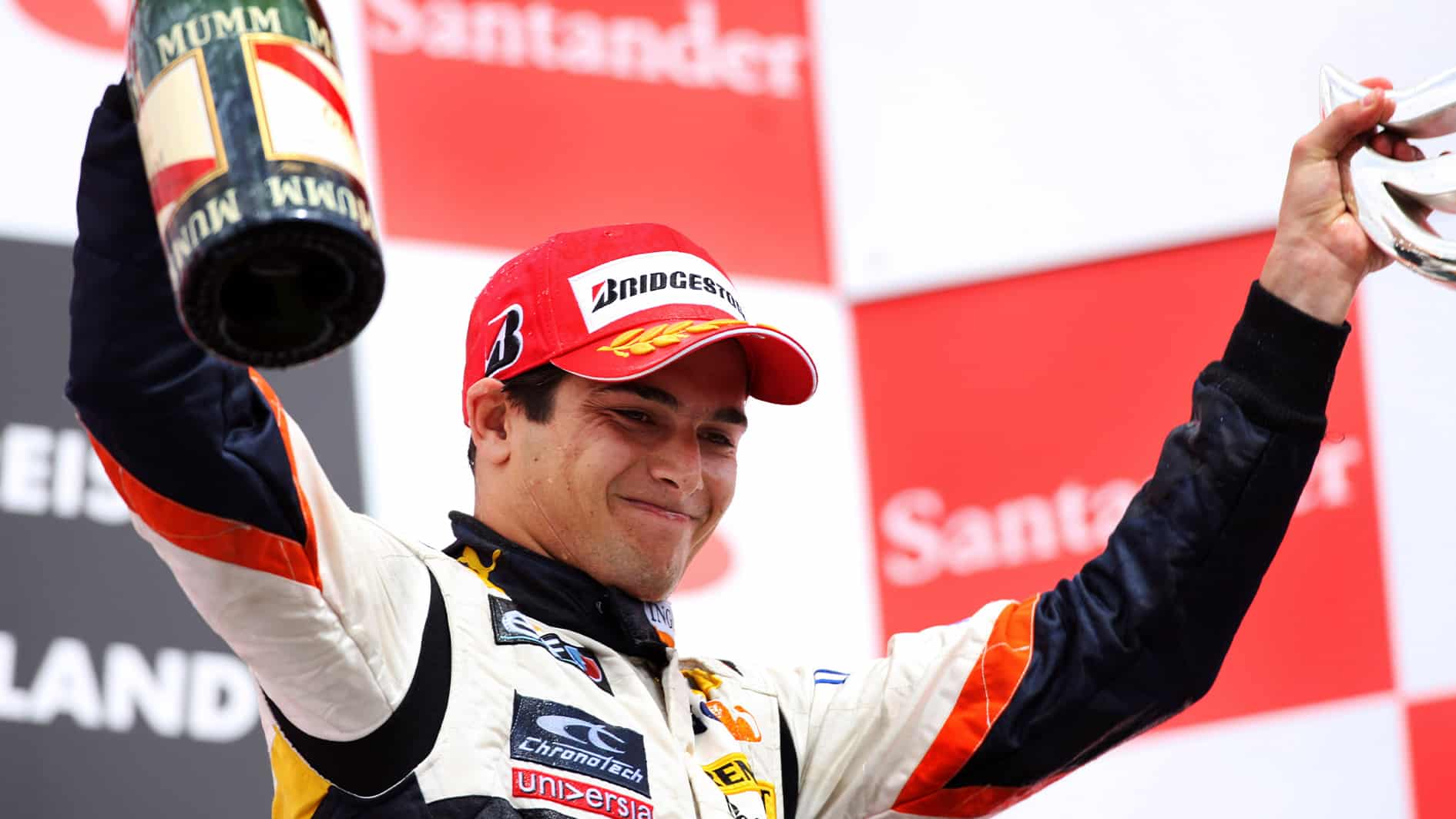 Nelson Piquet holds uop champagne bottle on 2008 German GP podium