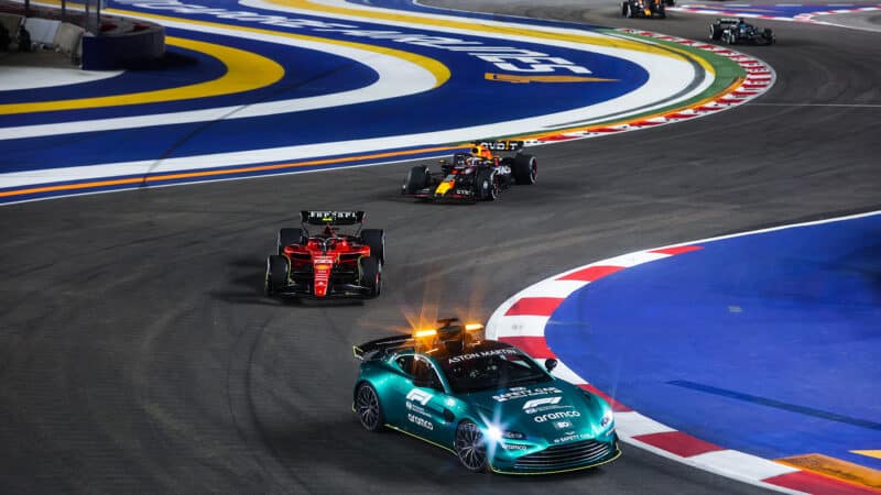 Aston Martin F1 safety car ahead of Carlos Sainz and Max Verstappen in 2023 Singapore GP