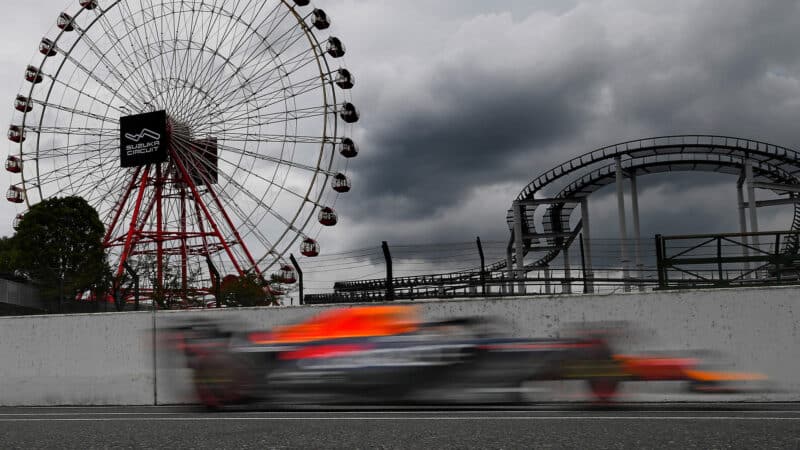 Blurred picture of Max Verstappen Red Bull driving past Suzuka ferris wheel