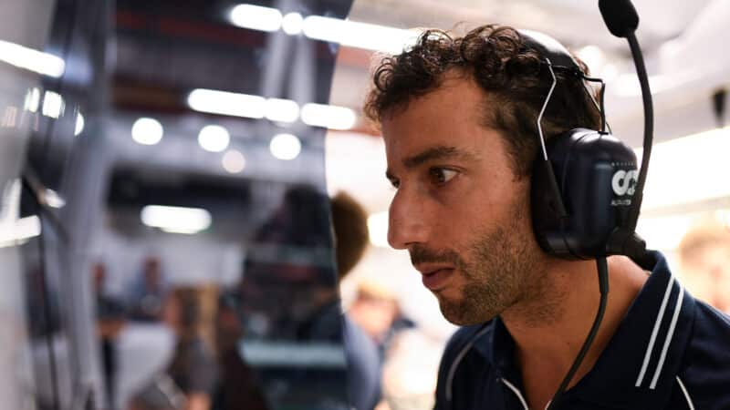 Danie Ricciardo examines telemetry in AlphaTauri pit garage