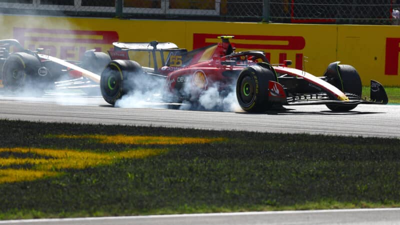 Ferrari of Carlos Sainz locks up under pressure from Max Verstappen in 2023 F1 Italian GP