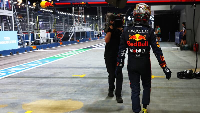 Max Verstappen walks down the Singapore pitlane after being eliminated from qualifying