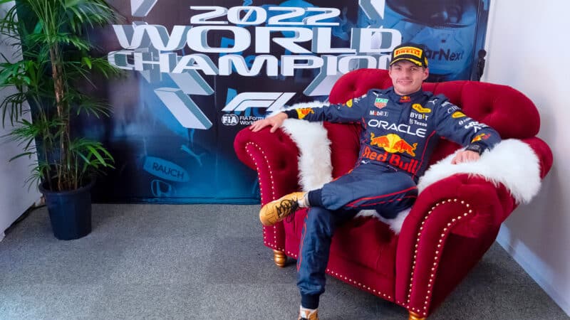 Max Verstappen sits on red armchair after winning 2022 F1 world championship