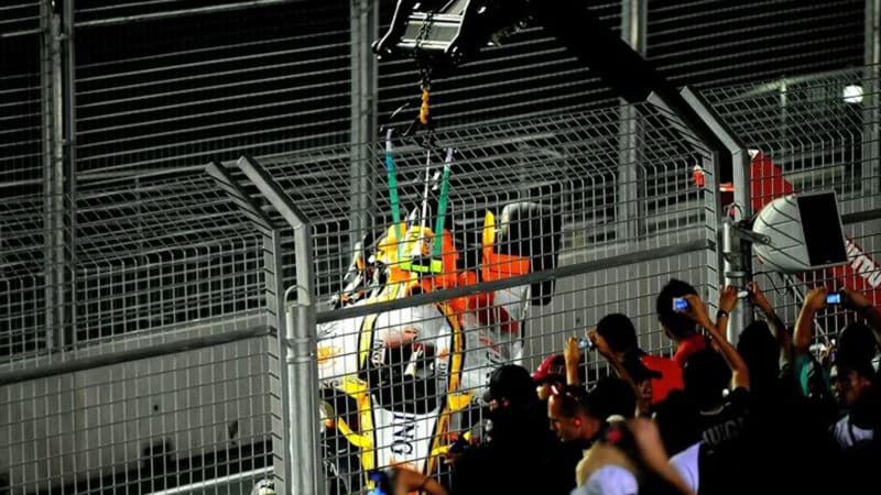 Nelson Piquet Renault is lifted off the track by crane after his deliberate crash in 2008 Singapore Grand Prix