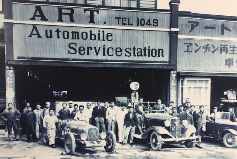 Soichiro Honda with mechanics outside his repair shop in 1931
