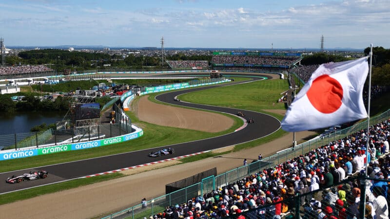 Suzuka Esses with Japanese flag in foreground