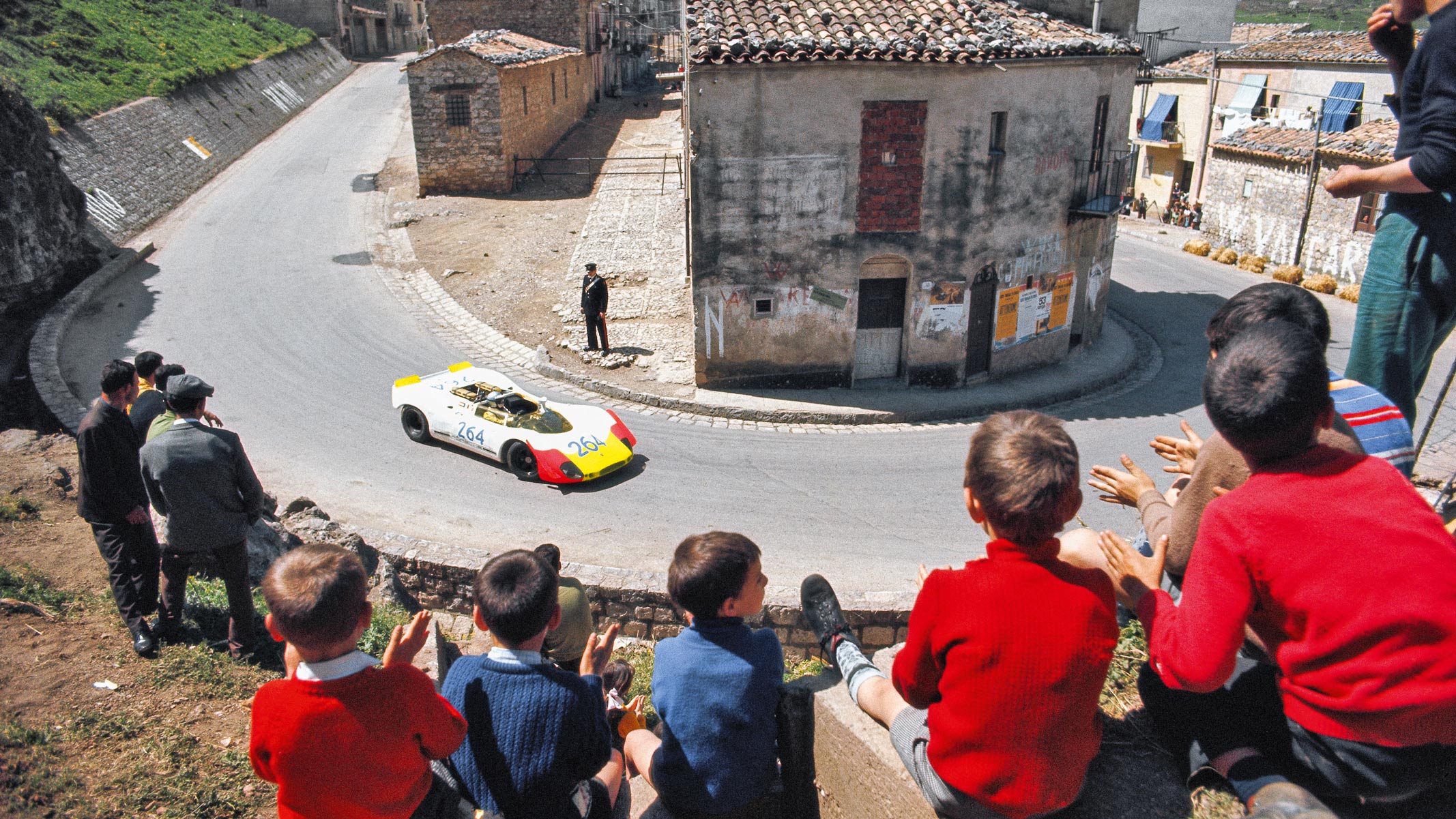 Children clap the Porsche 908/02 of Rudi Lins and Gerard Larrousse