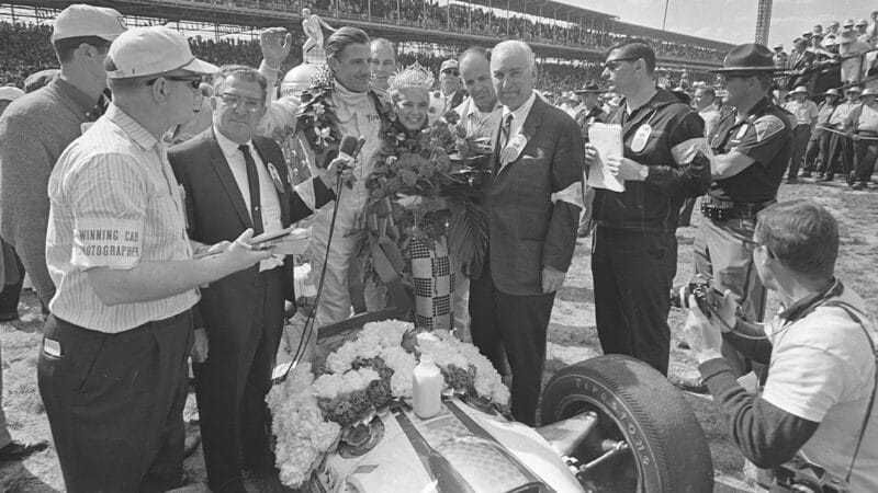 Graham Hill poses with his Lola after winning 1966 Indy 500