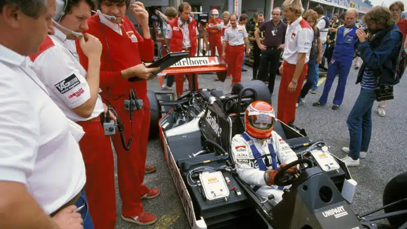 John Barnard and McLaren crew with Niki Lauda in bare carbon McLaren MP4