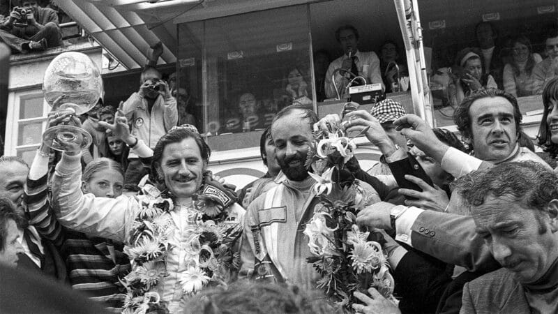 Graham Hill and Henri Pescarolo celebrate 1972 Le Mans victory on the podium