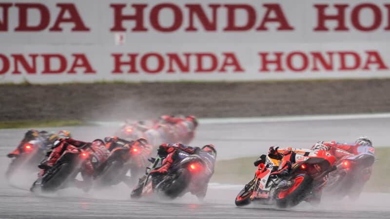 MotoGP bikes kick up spray at 2023 Japanese Grand Prix