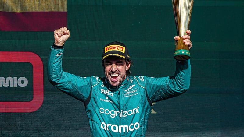 Fernando Alonso stands on the podium 2023