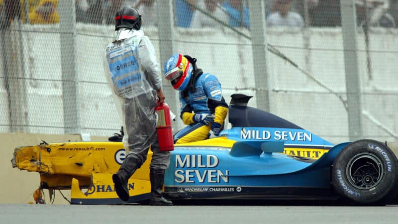 Fernando Alonso climbs out of his wrecked Renault at the 2003 Brazilian Grand Prix