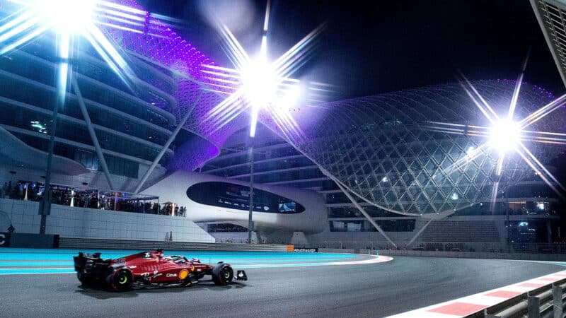 Ferrari of Charles Leclerc underneath lights of Yas Marina circuit