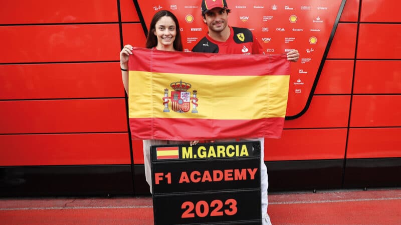 champion Marta Garcia with fellow Spaniard Carlos Sainz