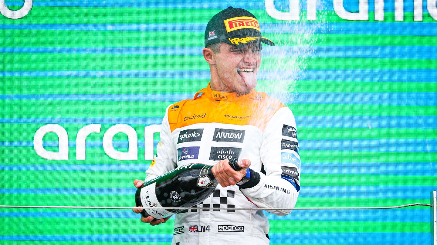 Lando Norris stands on the podium at 2023 British Grand Prix