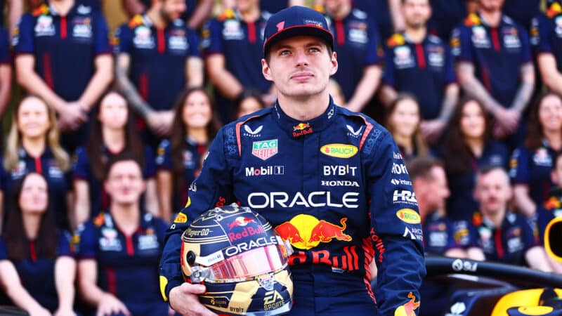 Max Verstappen poses with championship-themed helmet after 2023 F1 season