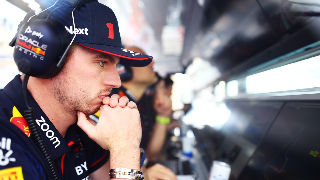 Max Verstappen watches data on the Red Bull F1 pitwall
