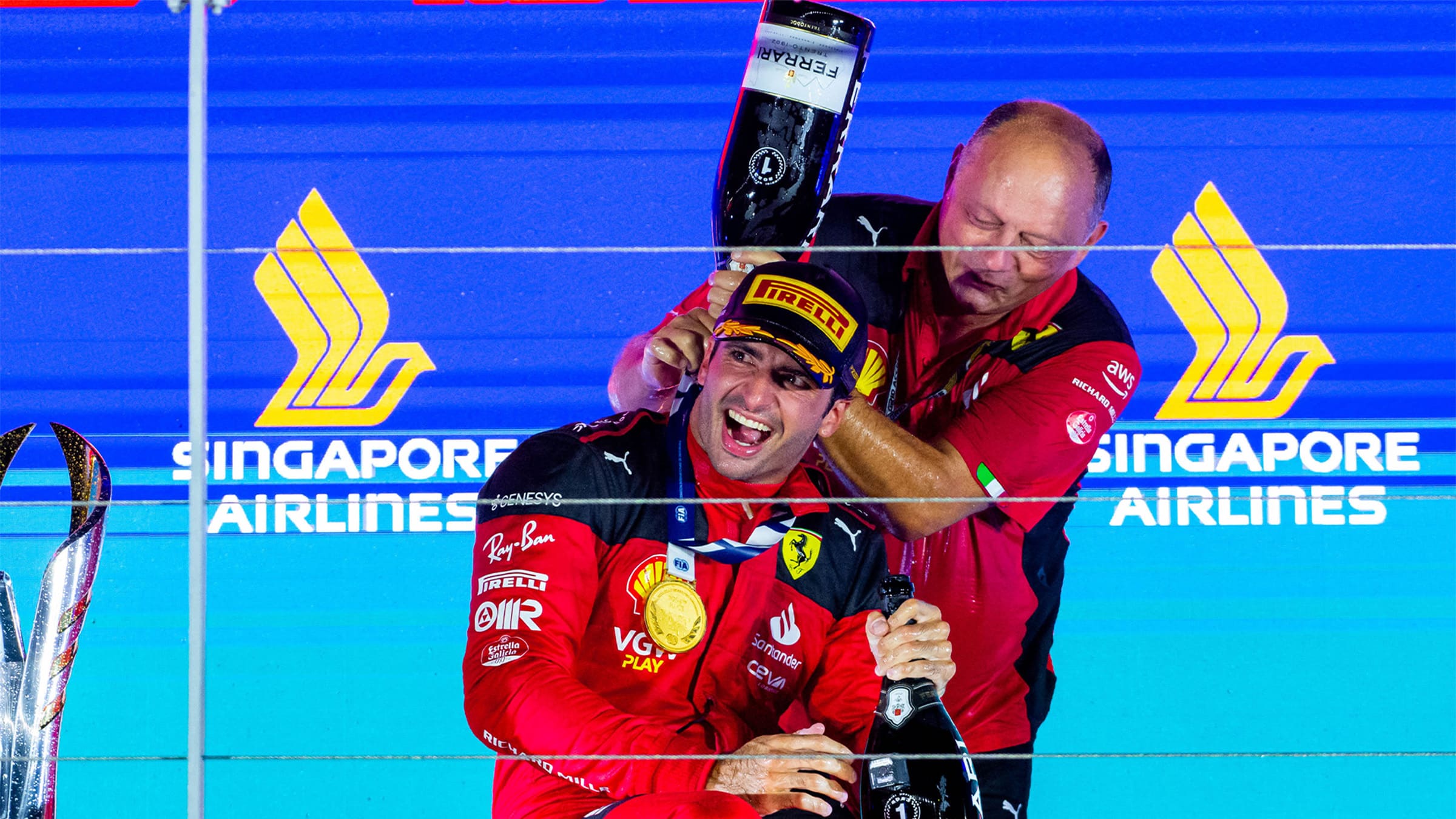 Carlos Sainz and Fred Vasseur celebrate on the podium of 2023 Singapore Grand Prix