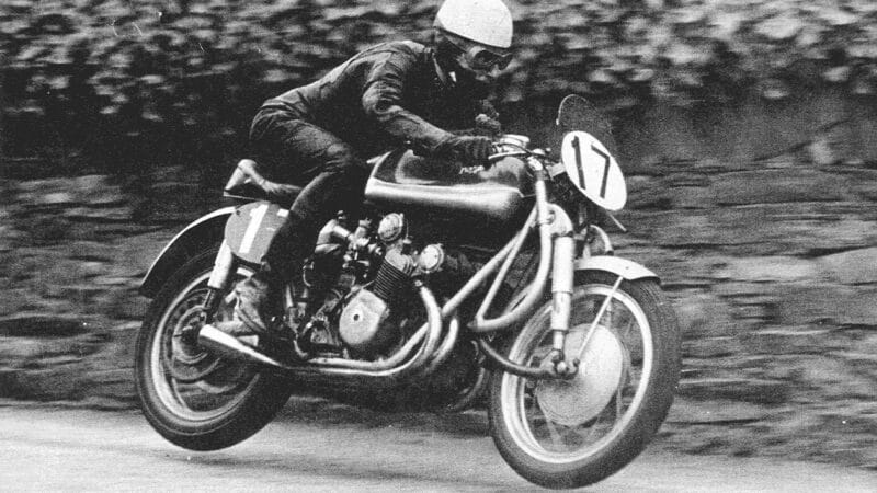 Les Graham with both wheels in the air on his MV Agusta in 1952 Isle of Man TT