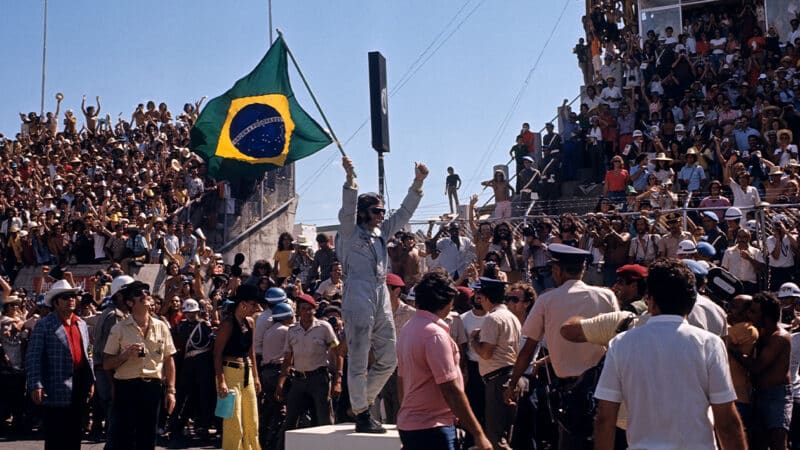 Emerson Fittipaldi waves Brazilian flag at 1973 Brazilian Grand Prix