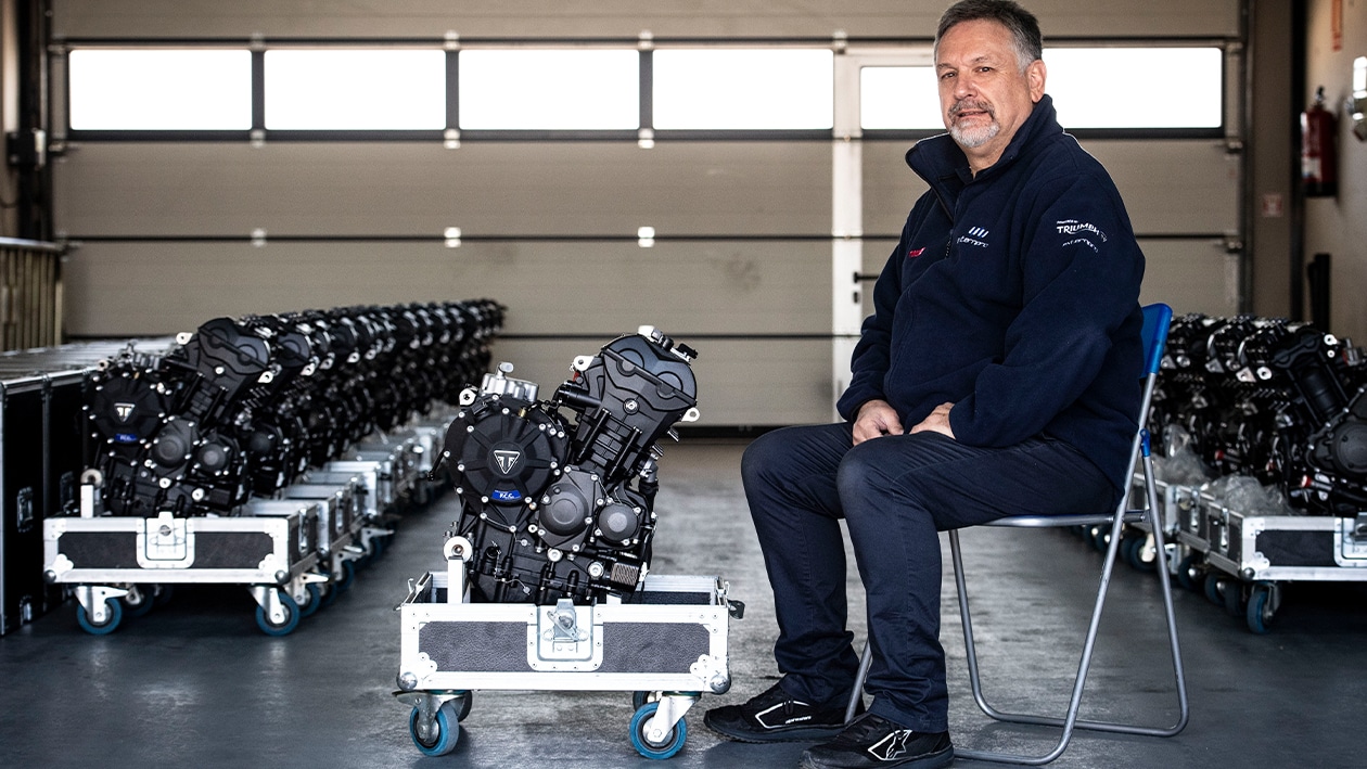 Trevor Morris with Triumph Moto2 engines in pit garage