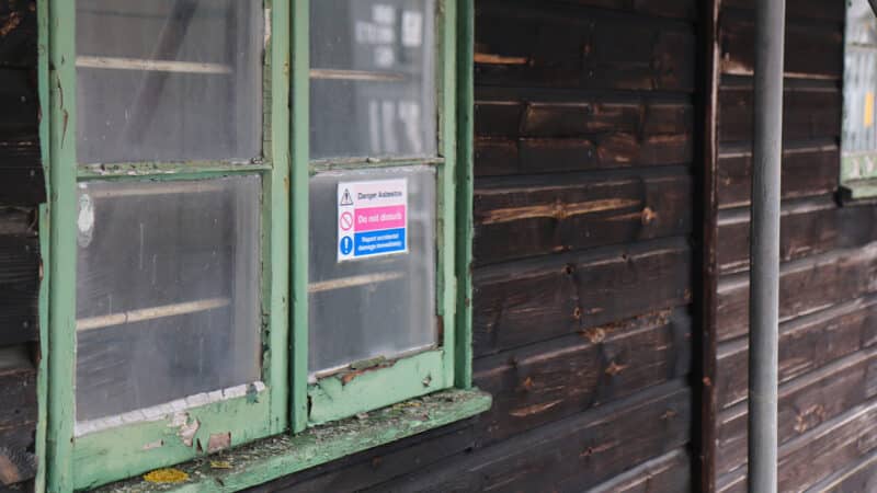 Tyrrell shed with peeling paint and asbestos sign
