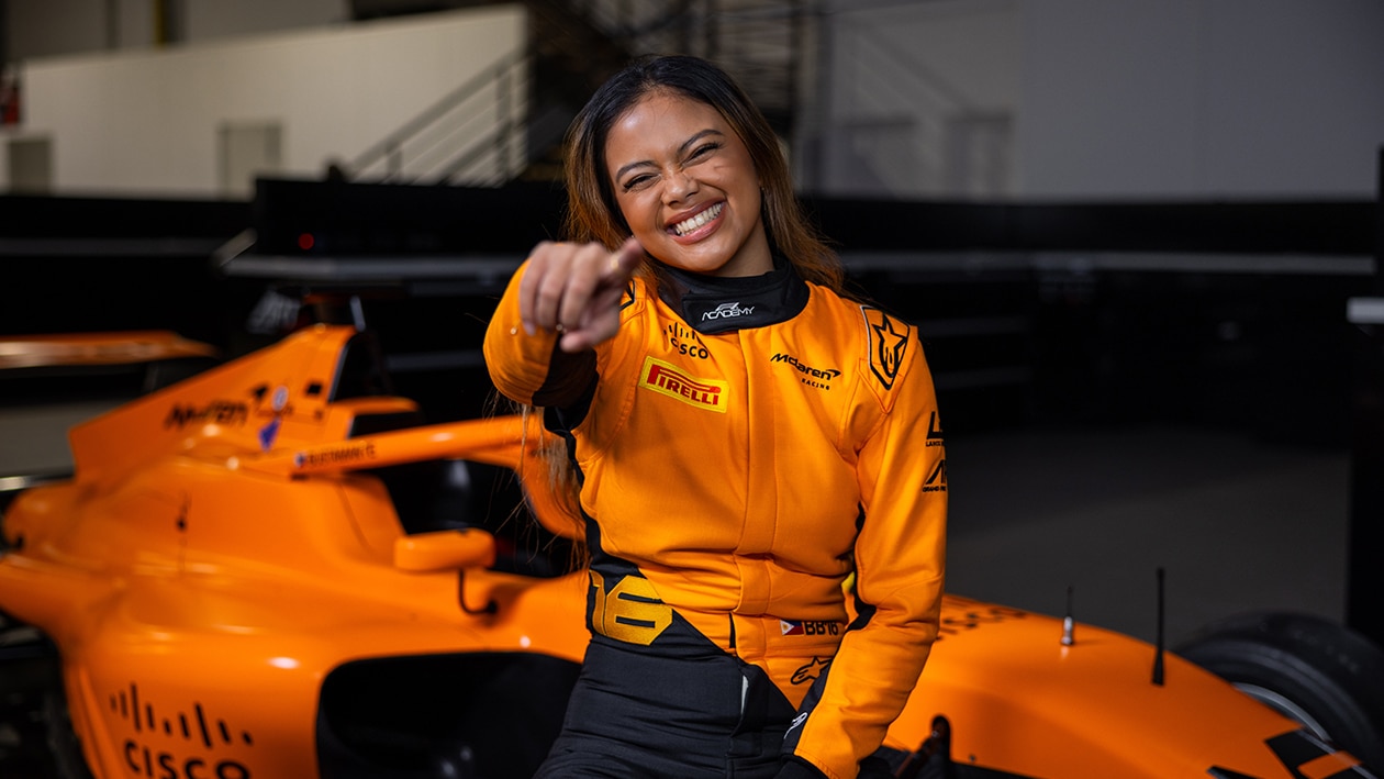 Bianca Bustamante next to McLaren F1 Academy car