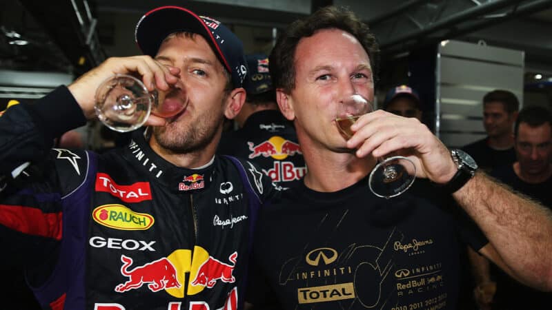 Christian Horner and Sebastian Vettel sip champagne after 2013 Indian Grand Prix