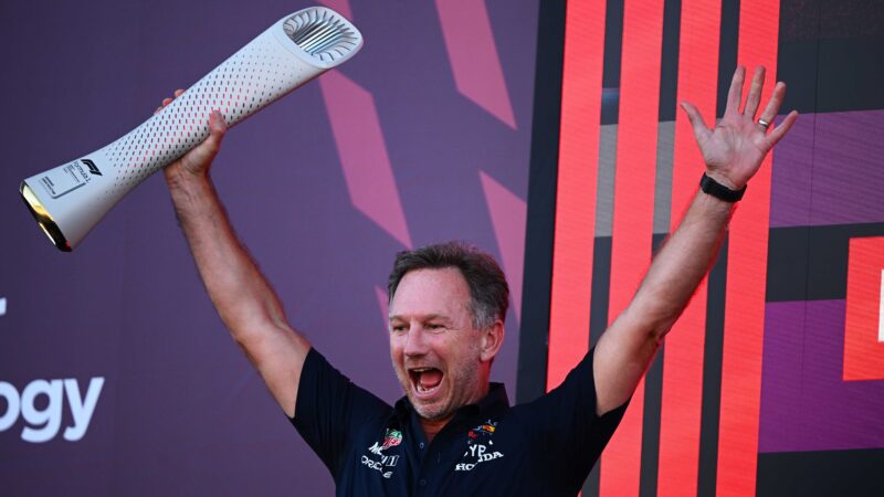 Christian Horner holds trophy above his head on 2023 F1 Japanese GP podium