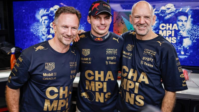 Christian Horner with Max Verstappen and Adrian Newey in Red Bull F1 garage with 2022 champions t-shirts