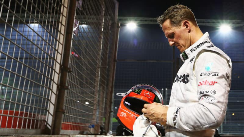 Michael Schumacher with bowed head at the side of the track after crashing in the 2012 Singapore GP