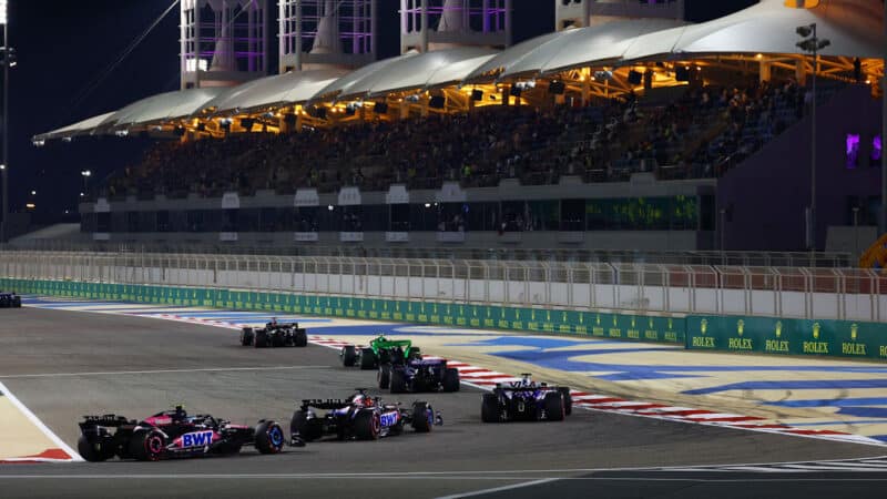 Two Alpine F1 cars at the back of the field in 2024 Bahrain GP