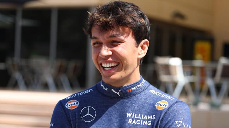 Alex Albon laughs in F1 paddock at 2024 Bahrain Grand Prix