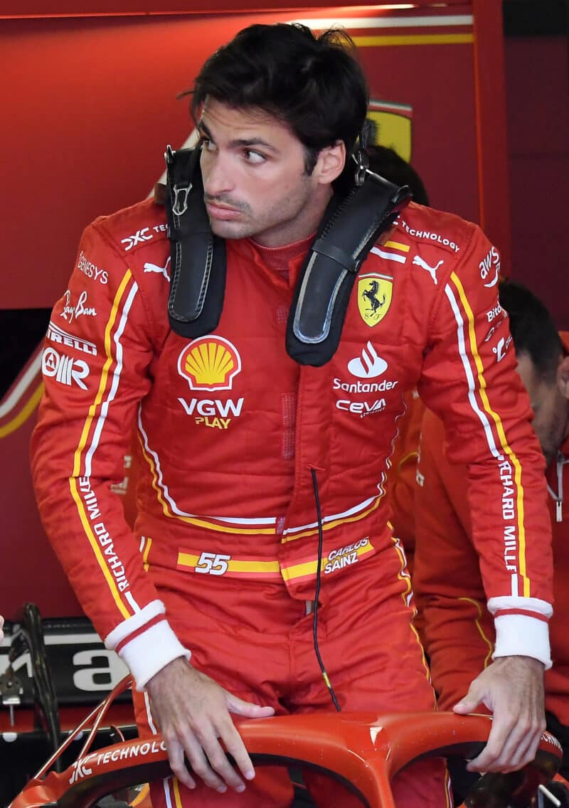 Carlos Sainz Jr gets into his Ferrari before practice for the 2024 Australian Grand Prix