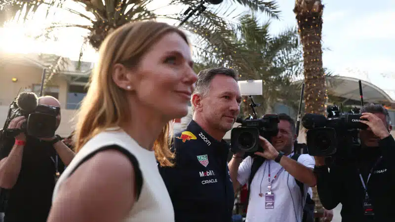 Christian and Geri Horner in 2024 f1 Bahrain Grand Prix paddock surrounded by photographers