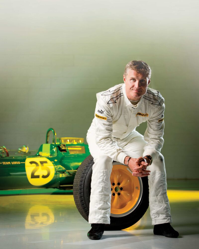 David Coulthard sits on Lotus 25 tire