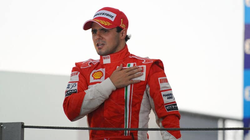 Felipe Massa puts his hand over Ferrari badge after winning the 2008 Brazilian Grand Prix but losing the championship
