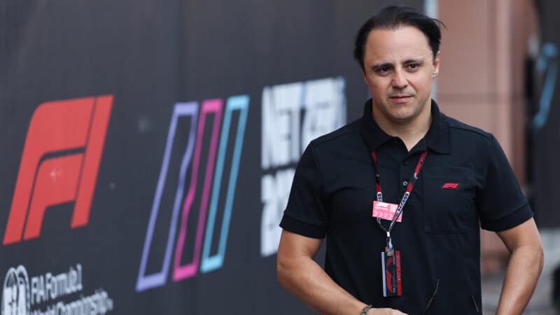 Felipe Massa walks past F1 sign in 2023 Minaco GP paddock