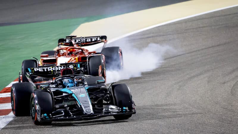 Ferrari of Charles Leclerc locks up as he follows Mercedes of George Russell in 2024 F1 Bahrain GP