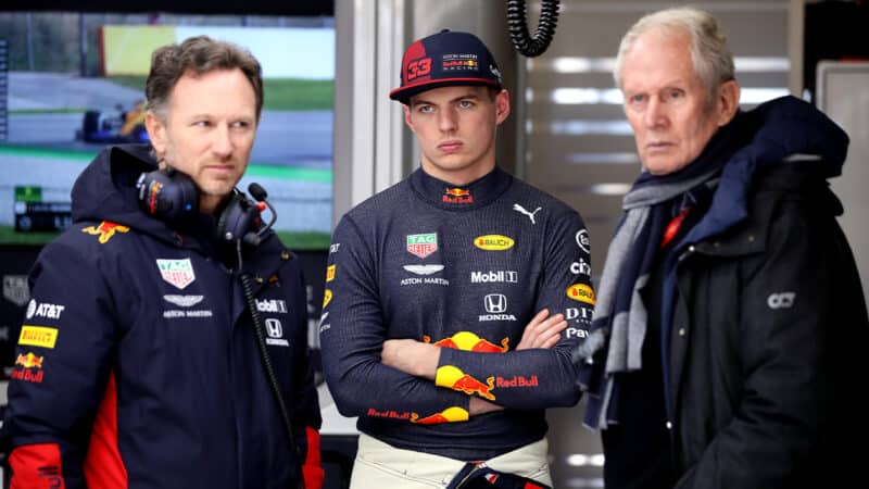 Max Verstappen between Christian Horner and Helmut Marko in Red Bull F1 pit garage