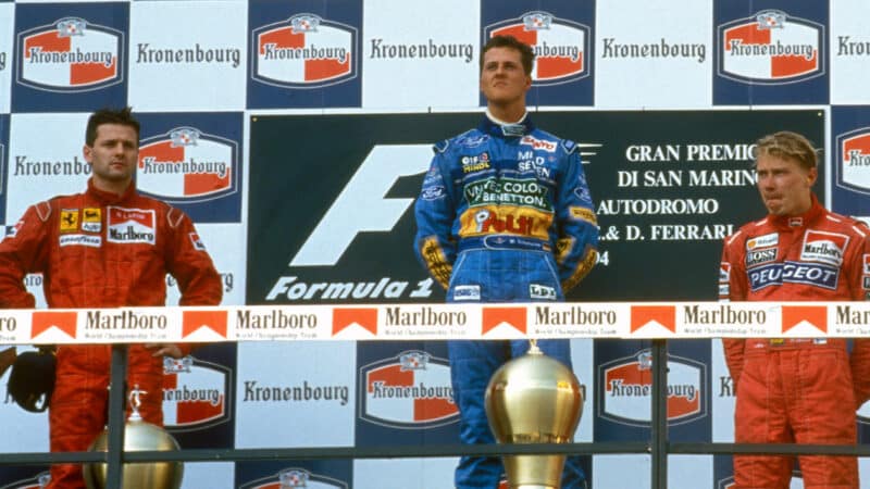 Michael Schumacher with Nicola Larini and Mika Hakkinen on podium at 1994 San Marino Grand Prix
